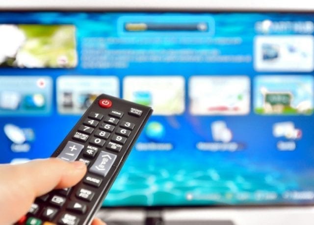 person using remote control on tv