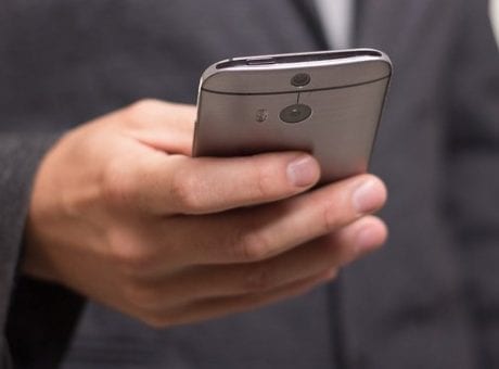 man in suit holding phone