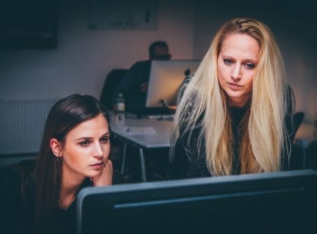 two women looking at screen