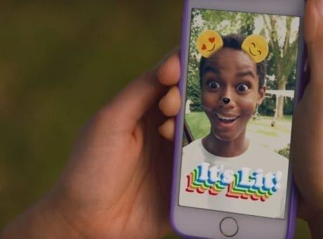 kid smiling on smartphone screen