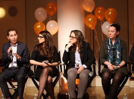 group of people on chairs with balloons