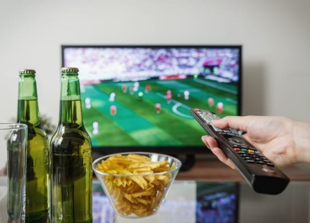 sports on tv with remote control, beers and chips