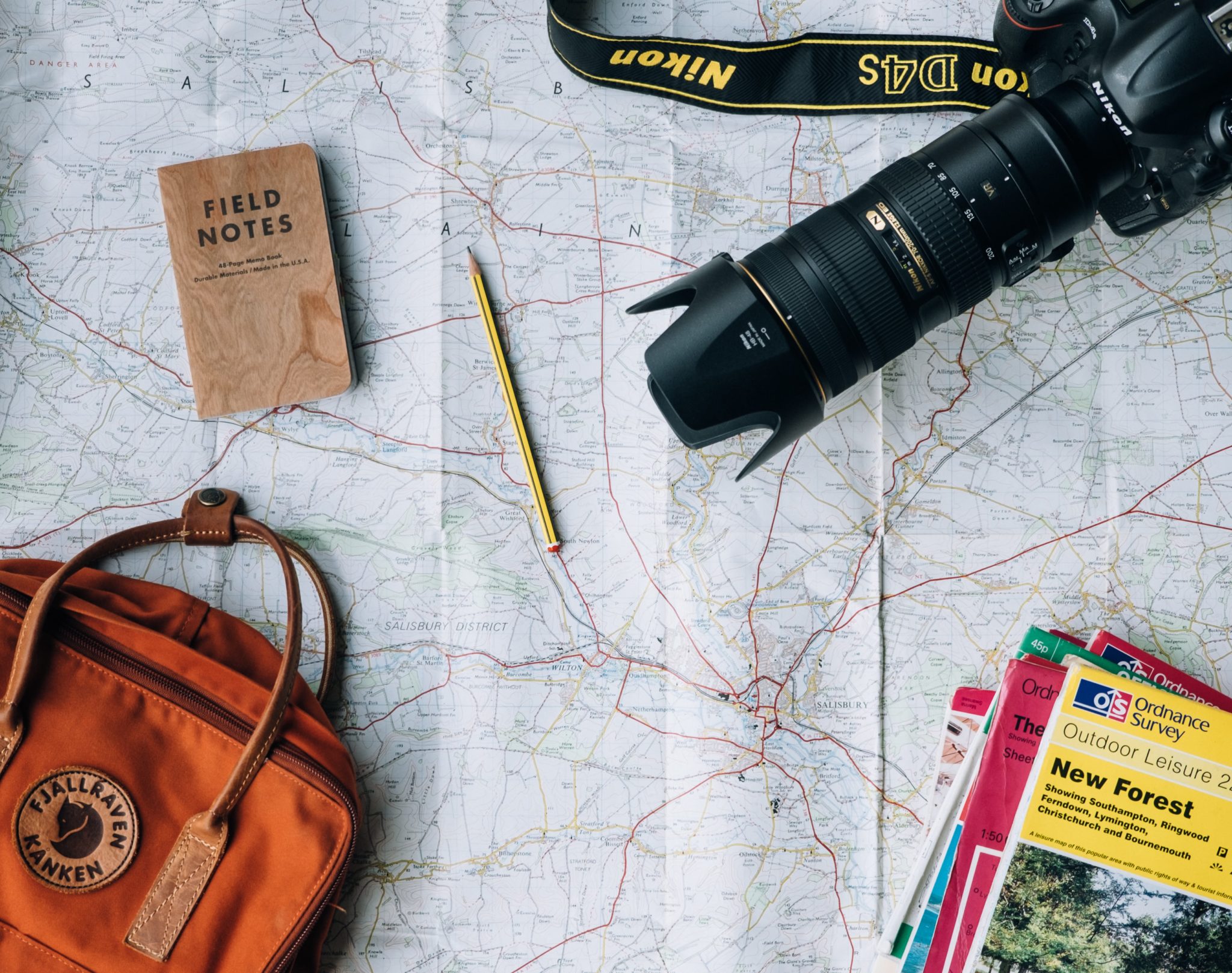 Photo of map and camera and other travel related items